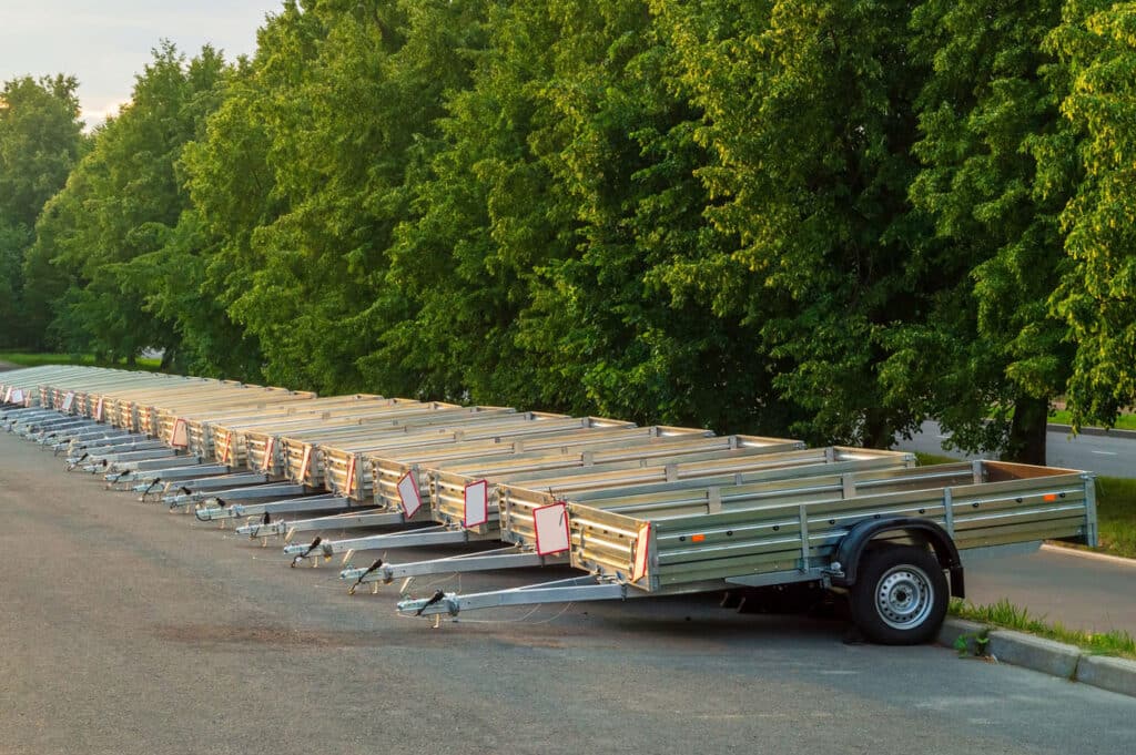 row of trailers with trees in the background